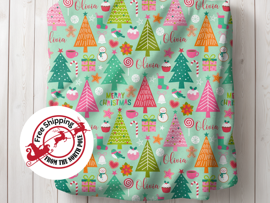 a green christmas wrapping with trees and candy canes